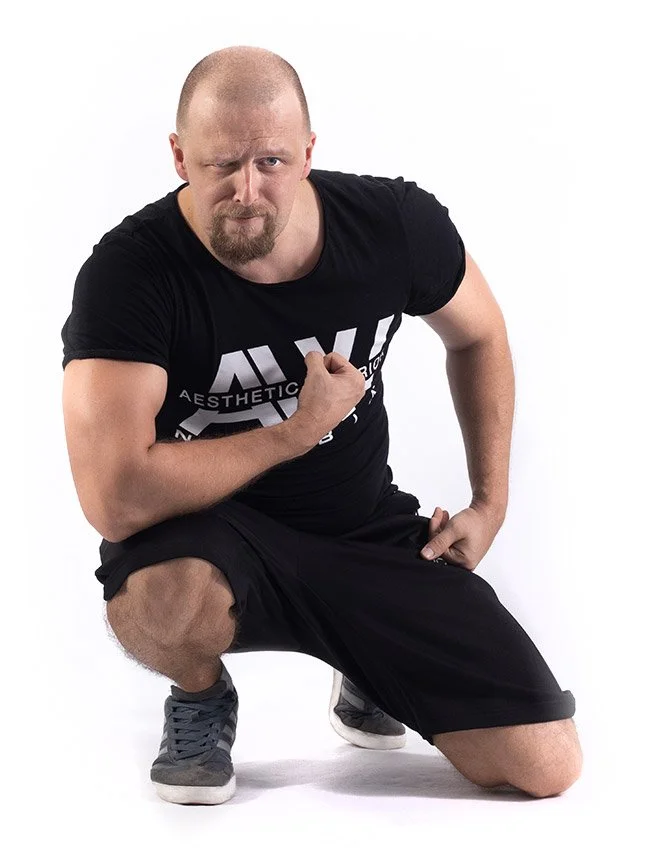 Lukáš Faltus, co klečí a ukazuje svaly